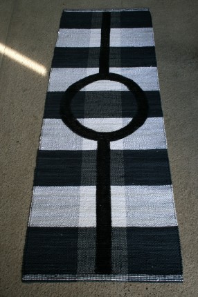 Rag Rugs "Kick Off". Handweaved in a striped bottom supplemented with a textile printing. Cotton. Design Elisabeth Johansson.